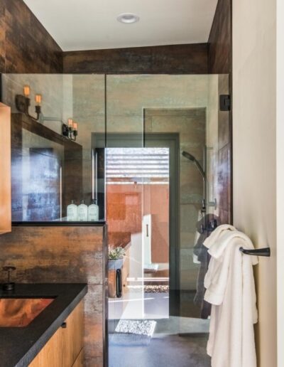 Modern bathroom interior with double vanity and walk-in shower.