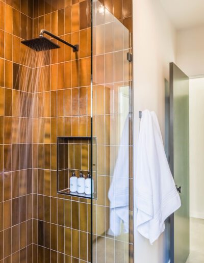 Modern bathroom with a glass-walled shower and running water.