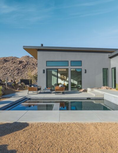 Modern house with a swimming pool in a desert landscape.