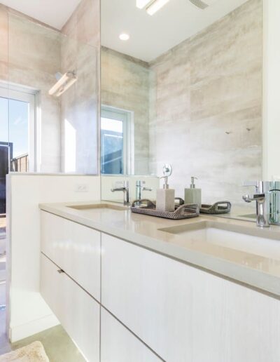 Modern bathroom with double vanity and desert view.