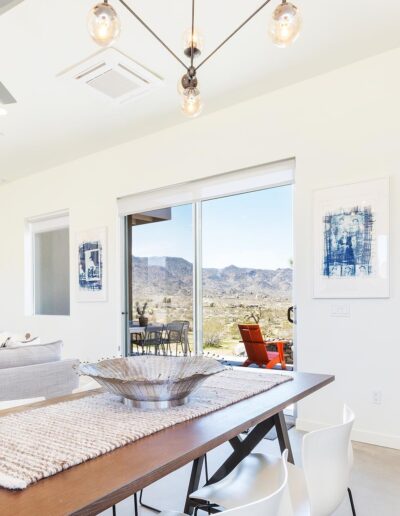 Bright, modern dining area with scenic view and contemporary art.